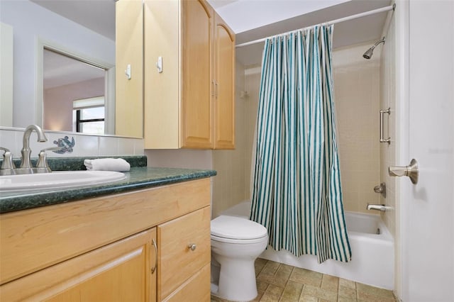 full bathroom with shower / bath combo, vanity, and toilet