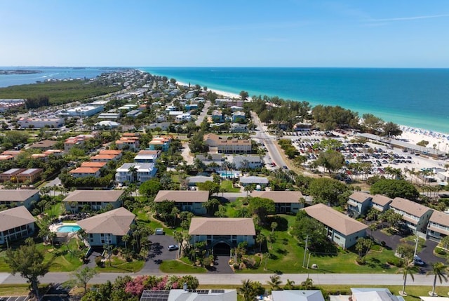 birds eye view of property with a water view and a beach view