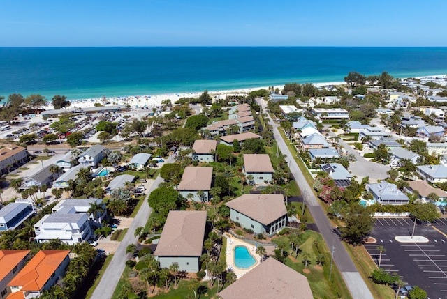 drone / aerial view with a water view and a beach view