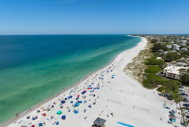 aerial view with a water view and a beach view