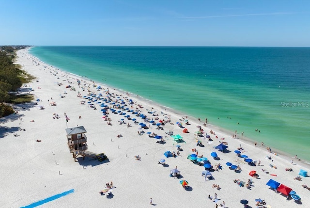 aerial view featuring a view of the beach and a water view