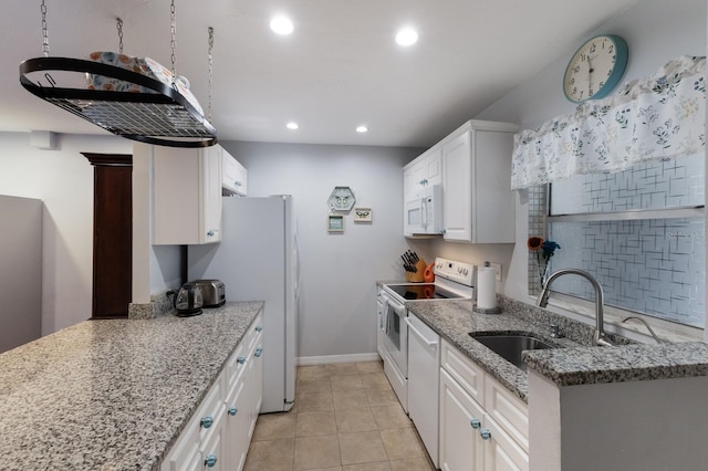 kitchen featuring white appliances, sink, light stone countertops, light tile patterned flooring, and white cabinetry