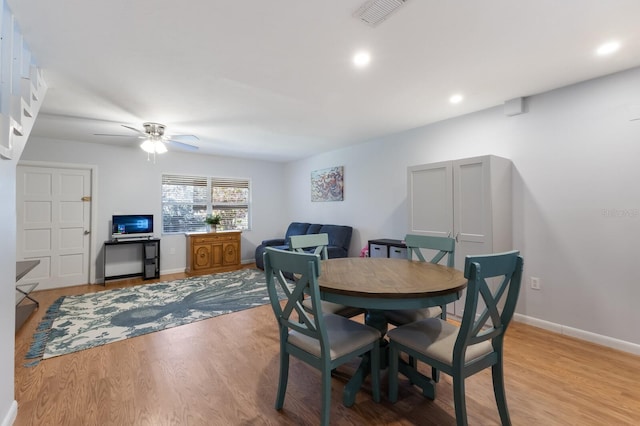 dining area with ceiling fan and light wood-type flooring