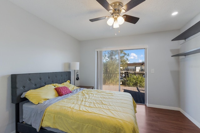 bedroom with access to exterior, a textured ceiling, dark hardwood / wood-style floors, and ceiling fan