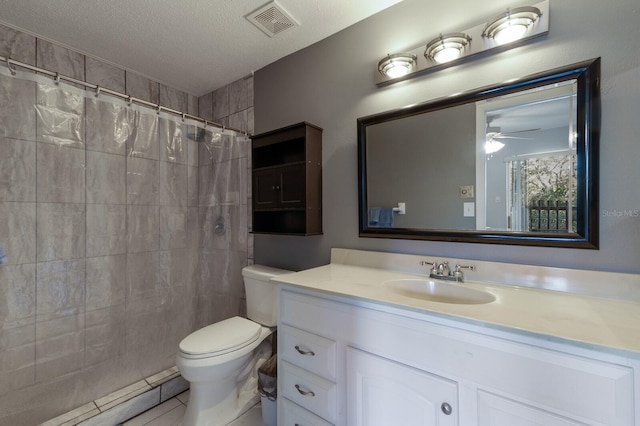 bathroom featuring vanity, ceiling fan, toilet, a textured ceiling, and curtained shower