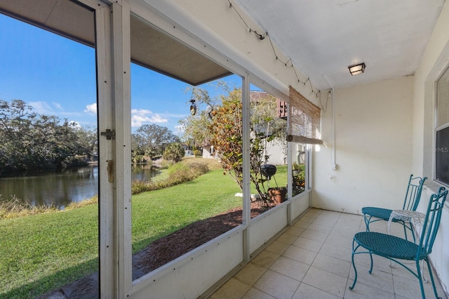 sunroom / solarium with a water view