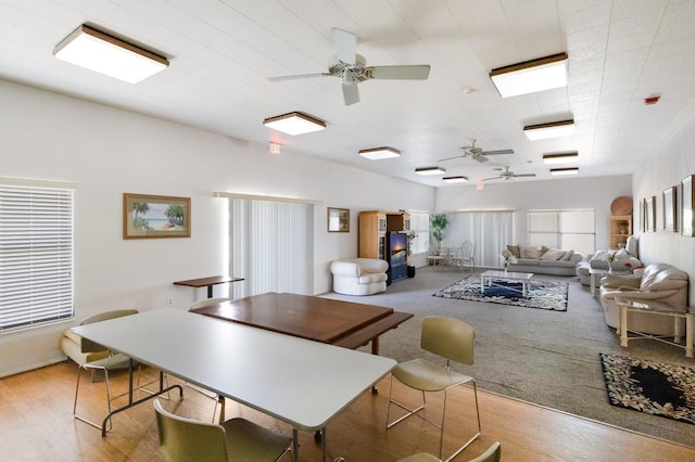 dining area featuring light hardwood / wood-style floors and a wood stove