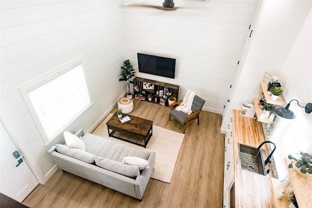 living room featuring hardwood / wood-style flooring, ceiling fan, and a wealth of natural light