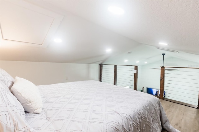 bedroom featuring light hardwood / wood-style floors and lofted ceiling