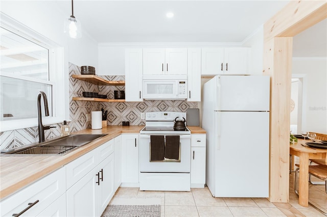 kitchen with pendant lighting, wood counters, white cabinets, and white appliances