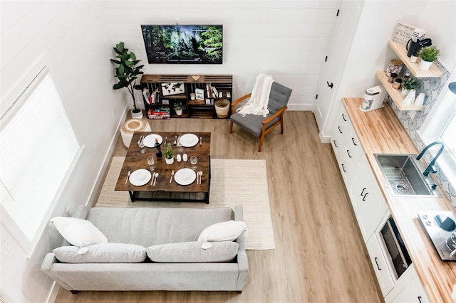 living room featuring light wood-type flooring and sink