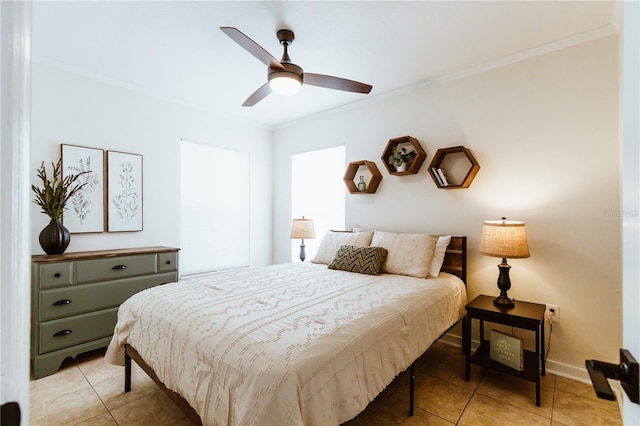 bedroom featuring ceiling fan, light tile patterned floors, and crown molding