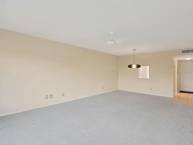 spare room with light colored carpet