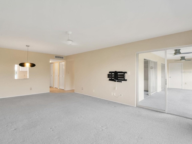 carpeted empty room featuring ceiling fan