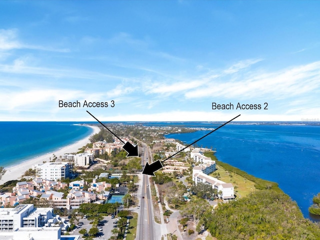 birds eye view of property with a water view and a view of the beach