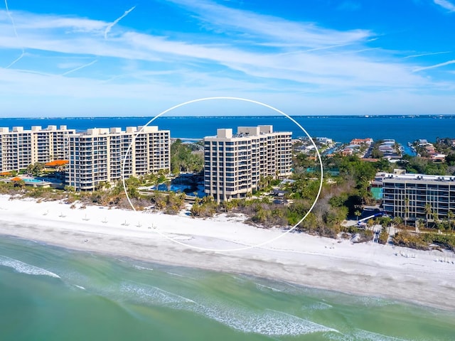 birds eye view of property featuring a beach view and a water view