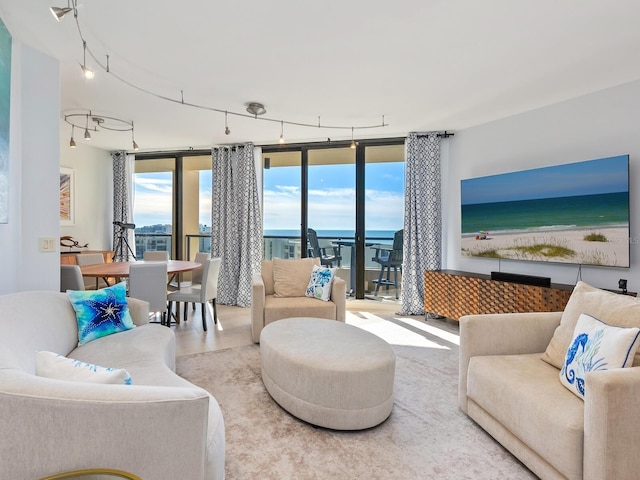 living room with expansive windows and a water view