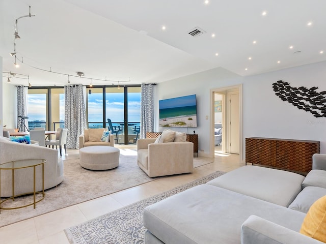 tiled living room featuring expansive windows and a healthy amount of sunlight