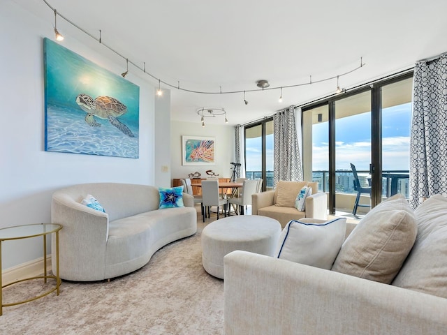 carpeted living room with floor to ceiling windows and a water view