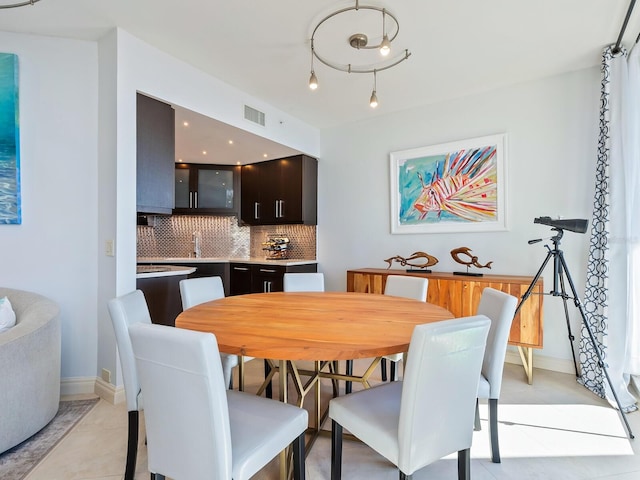 tiled dining area featuring sink