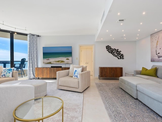 living room featuring floor to ceiling windows and light tile patterned flooring