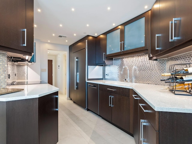 kitchen with decorative backsplash, light tile patterned flooring, sink, and stainless steel appliances