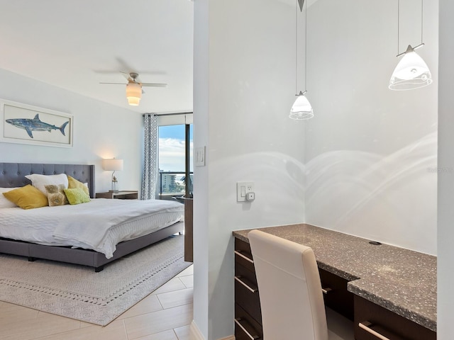 bedroom with ceiling fan and a wall of windows