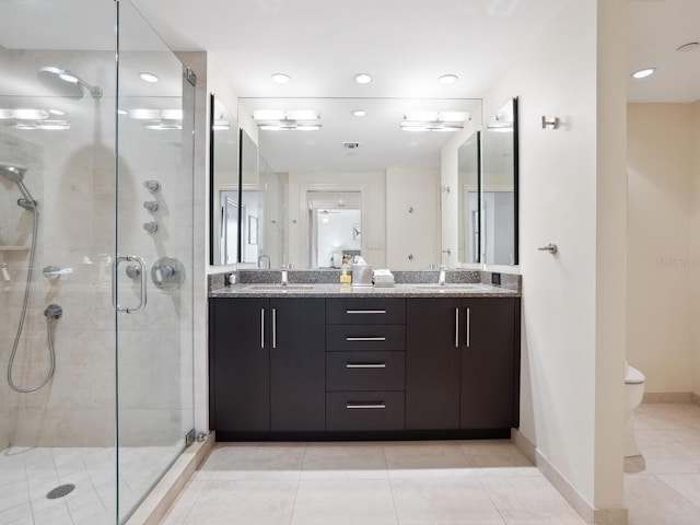 bathroom with vanity, tile patterned flooring, ceiling fan, toilet, and a shower with shower door