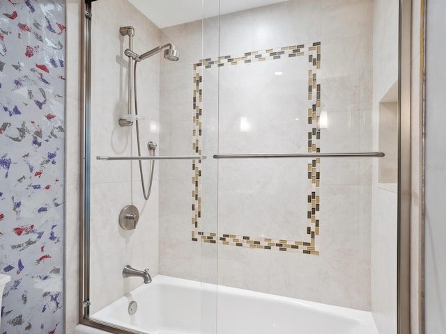 bathroom featuring bath / shower combo with glass door