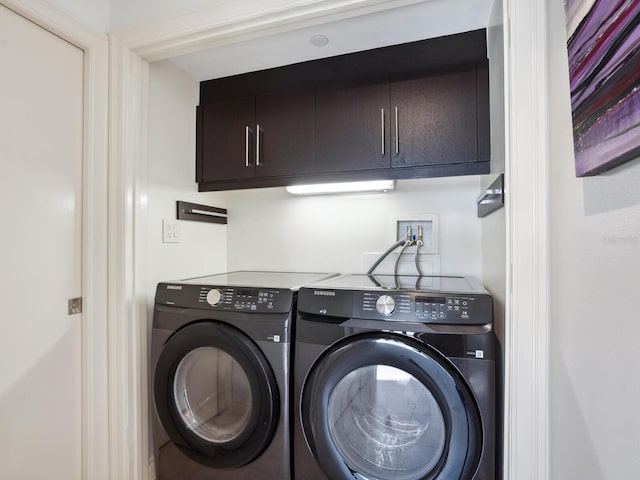 washroom with cabinets and independent washer and dryer