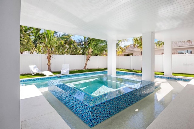 view of swimming pool with an in ground hot tub