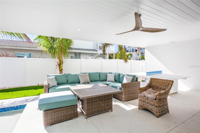 view of patio with an outdoor living space and ceiling fan