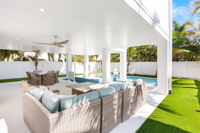 view of patio / terrace featuring ceiling fan and a fenced in pool