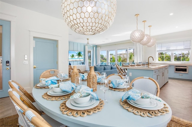 dining area with light hardwood / wood-style floors and sink