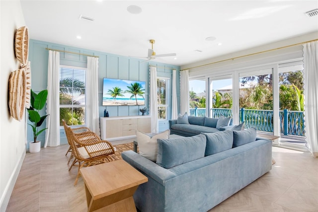 sunroom / solarium featuring ceiling fan