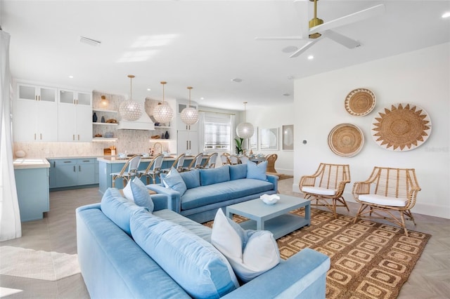 living room featuring ceiling fan and light parquet flooring