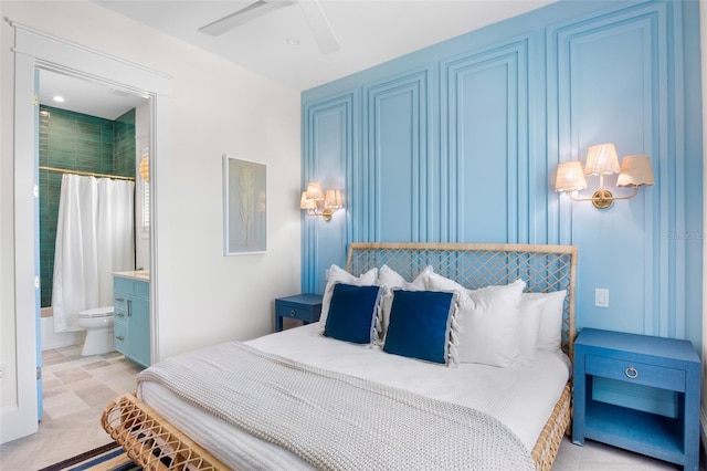 bedroom featuring ensuite bathroom and ceiling fan