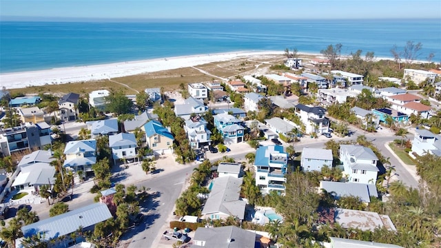 birds eye view of property with a water view and a view of the beach