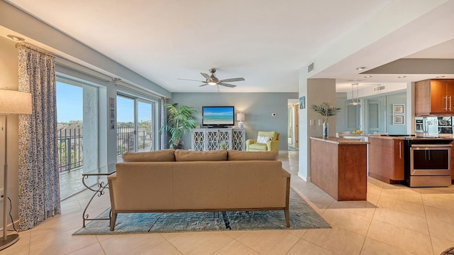 living room featuring ceiling fan and light tile patterned floors