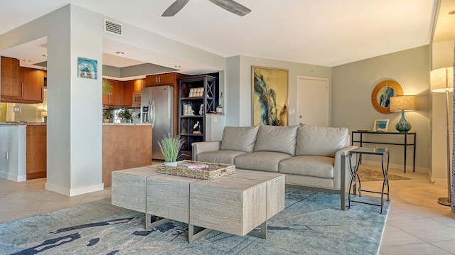 living room with ceiling fan and light tile patterned floors