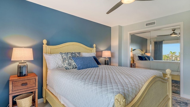 bedroom with ceiling fan, a closet, and hardwood / wood-style flooring