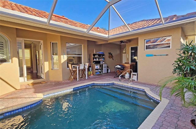 view of swimming pool featuring a lanai and a patio