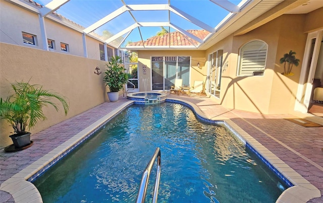 view of swimming pool with a patio area, an in ground hot tub, and glass enclosure