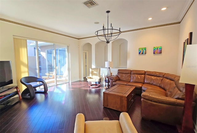 living room with crown molding, dark hardwood / wood-style floors, and a notable chandelier