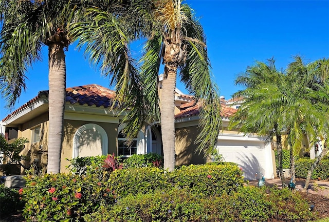 mediterranean / spanish house with a garage