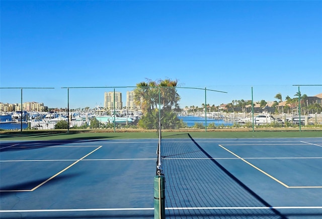 view of sport court with a water view and basketball court