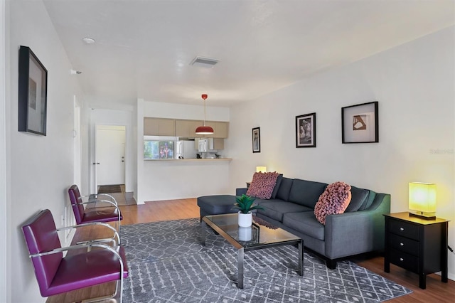 living room with dark hardwood / wood-style flooring