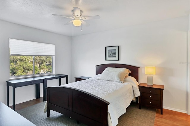 bedroom with ceiling fan and hardwood / wood-style flooring