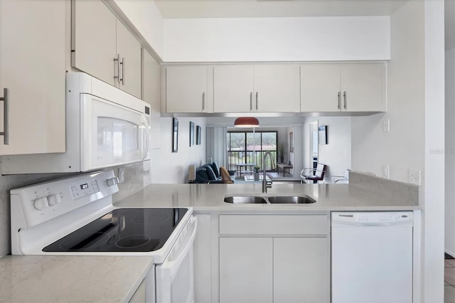 2124 N Tamiami Trl Unit 103, Sarasota, FL 34234 - kitchen featuring white appliances, a sink, light countertops, and white cabinets
