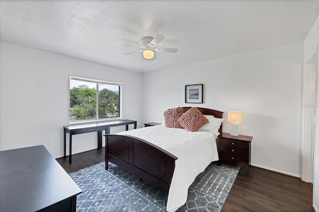 2124 N Tamiami Trl Unit 103, Sarasota, FL 34234 - bedroom with dark wood finished floors, baseboards, and a ceiling fan